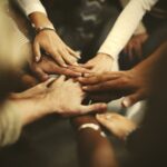 People stacking hands as a team